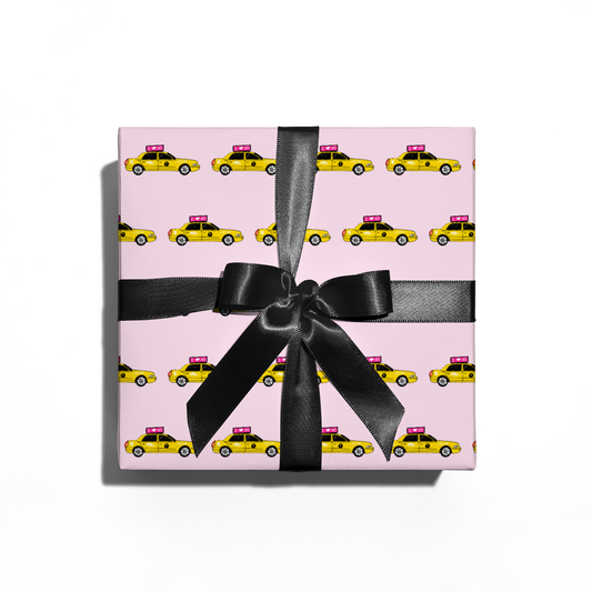 Gift box with taxi pattern and black ribbon on pink background